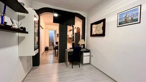 A narrow hallway with a desk and chair, a lamp, and a framed picture on the wall. - Holiday apartment in Pula, big roof balcony and garden, pet friendly (Pula)