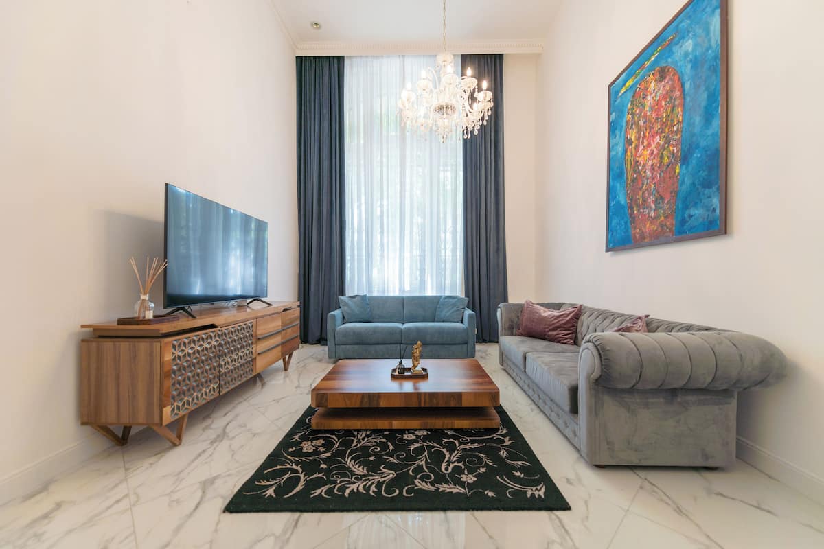 A modern living room with a TV, sofa, and coffee table.