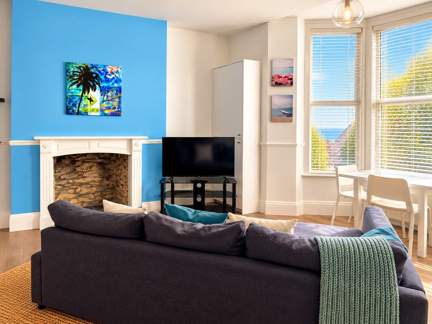 A living room with a fireplace, a television, and a sofa.