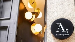 A staircase leading to a room with a sign indicating 'The A5 Smart luxury studios'.