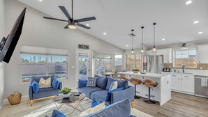 A modern living room with a sofa set, a coffee table, and a ceiling fan. - Recently renovated Phoenix home with private heated pool and mountian veiws  (Phoenix)