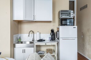 Fridge, coffee/tea maker, toaster, cookware/dishes/utensils