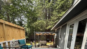 A wooden deck with outdoor furniture, a pergola, and a covered seating area. - Spacious family sized beach home - 15 minute walk to beach! (Old Orchard Beach)