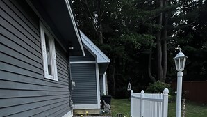 A pathway leading to a house with a white picket fence, a welcome sign, and decorative lights. - Spacious family sized beach home - 15 minute walk to beach! (Old Orchard Beach)