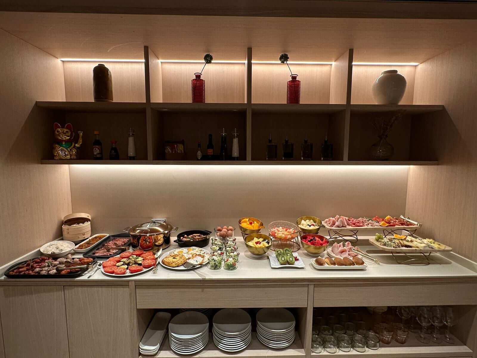 A buffet setup with various food items and condiments.