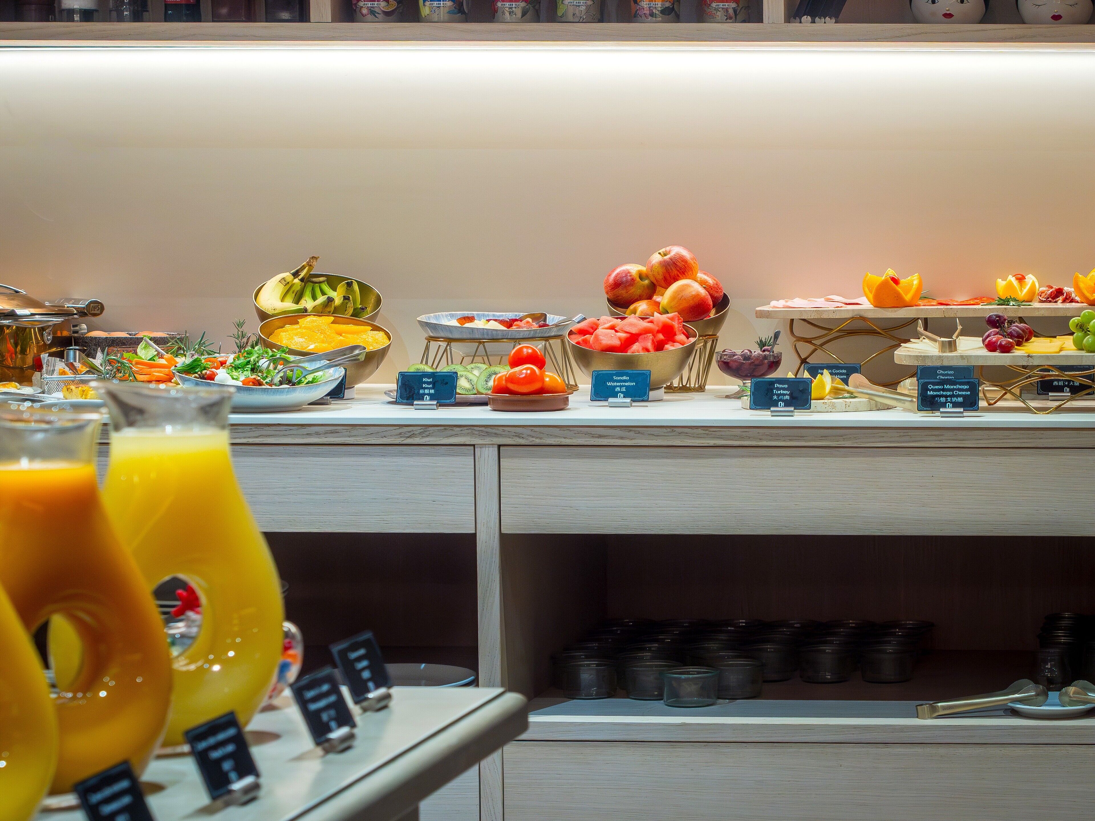 A buffet with various food items and drinks.