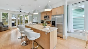 A modern kitchen with a central island, stainless steel appliances, and pendant lighting. - 3BR Modern Home in the Heart of St. Augustine (St. Augustine)