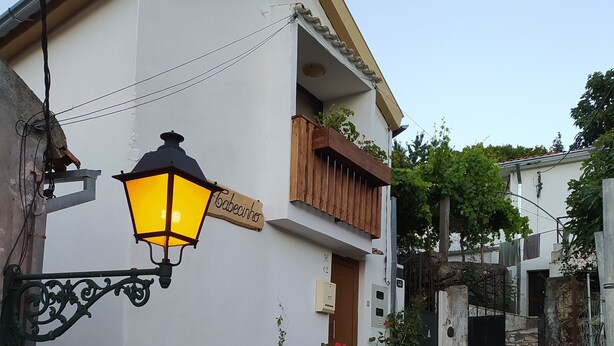 A building with a sign reading "Tabacinho" and a wooden balcony. - ABRIGO DO CABECINHO (Cortes do Meio)