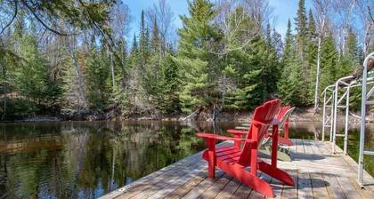 Sand Lake Getaway - Modern Riverfront Cottage w/ Swimming & Hot Tub