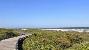 Ranta lähistöllä, aurinkotuoleja, rantapyyhkeitä