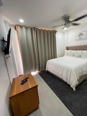 Suite, 2 Queen Beds, Balcony, Garden View | Desk, laptop workspace, iron/ironing board, bed sheets - Best Western Grand Baymen Gardens (San Pedro)