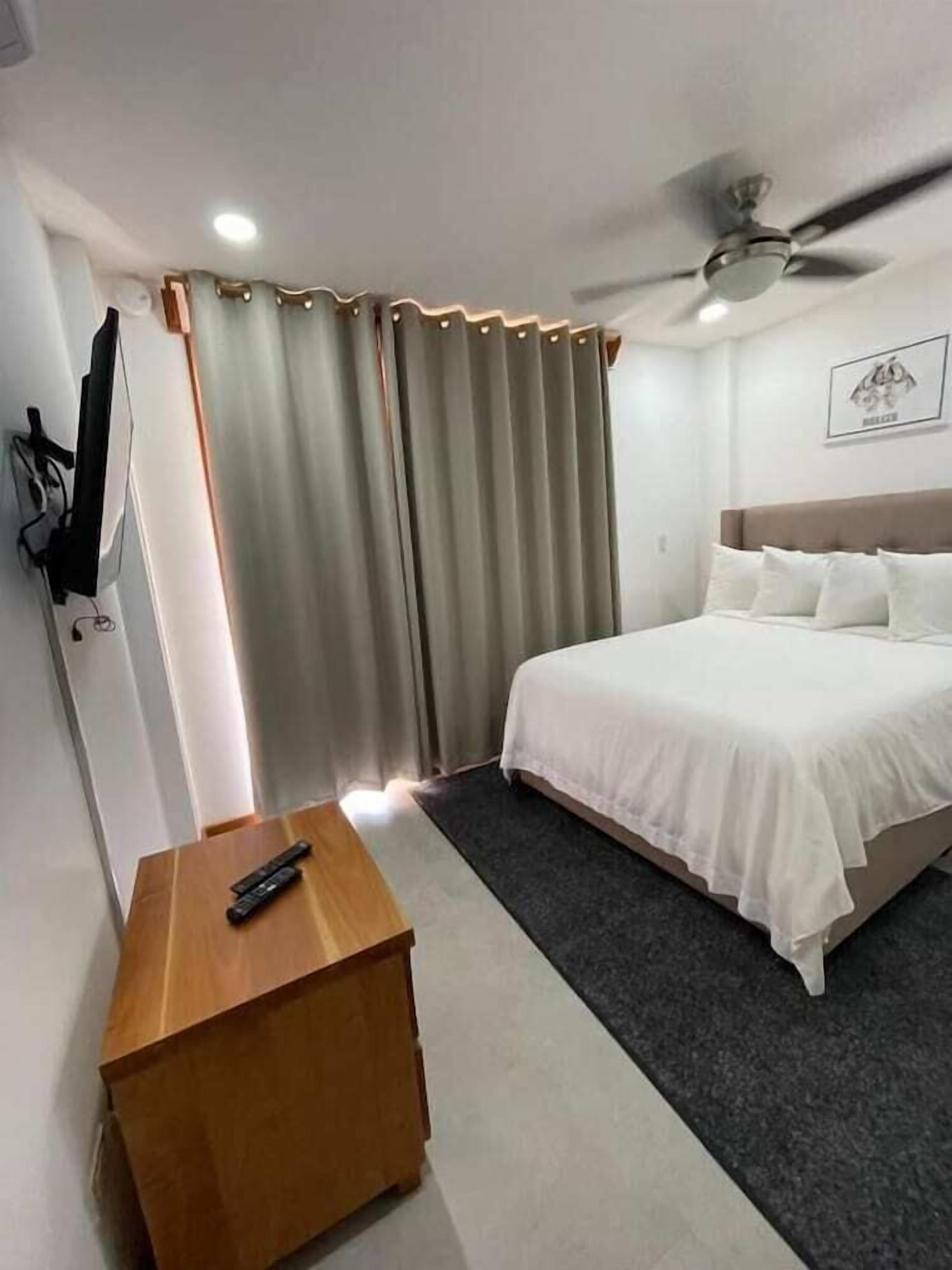 Desk, laptop workspace, iron/ironing board, bed sheets