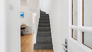A staircase with carpeted steps leading to a landing. - City Reach (Exeter)