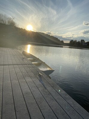 A wooden dock extending into calm water with a rowboat tied to it. - Historic intown waterfront w/PRIVATE dock & pool on 8.5 acres.  (Belfast)