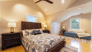 A bedroom with a large bed, two bedside tables, a ceiling fan, and a window with blinds. - OFF THE HOOK - 3 Bedroom / 3 Bathroom W/ Pool & Parking (Key West)