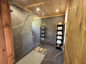 Bathtub, hair dryer, towels, toilet paper
