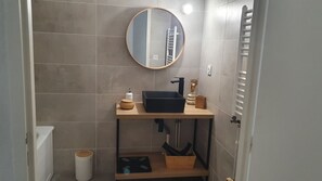 Bathtub, hair dryer, towels, toilet paper