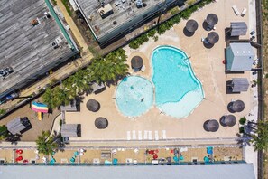 An aerial view of a resort with two swimming pools, sun loungers, and a beach area. - Resort Pool, 5 Bedroom, Spacious, King Beds, Near White Cap Beach, Patio, Grill (Corpus Christi)