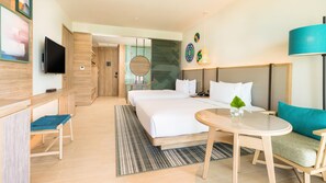 A hotel room with a bed, a desk, a chair, a round table, and a TV. - Holiday Inn Resort Samui Bophut Beach (Koh Samui)