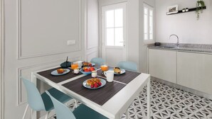 A dining area with a table set for breakfast, including plates of food, drinks, and a coffee machine. - ♥ Unique & Stylish Historic House ♥ Great Location ♥ Close to Gardens & River (Leiria)