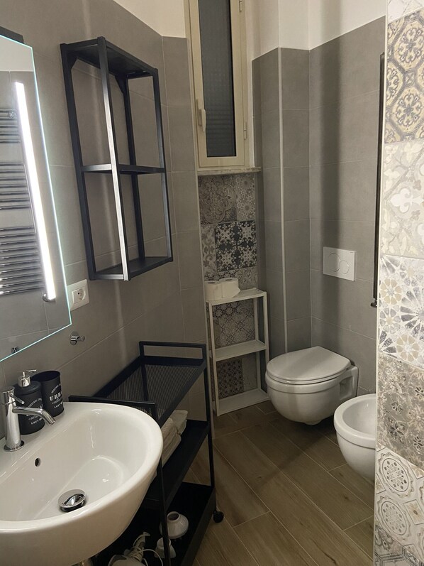 A modern bathroom with a white sink, a black medicine cabinet, a toilet, and a shower area. - Rome Accommodation Rent Apartment "residence San Pietro" Elegant Period Building St. Peter's Mansion Holiday Apartment Holiday Rent Apartment Mansion (Roma)