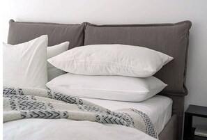 Cozy retreat with a neatly made bed and a comfortable nightstand.