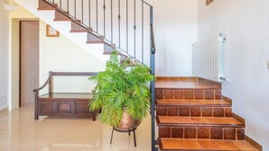 A staircase with a metal railing, a potted plant, and a bench. - CASA CATALINA SAROLA - Village house with a swimming pool in the north of Mallorca (Campanet)