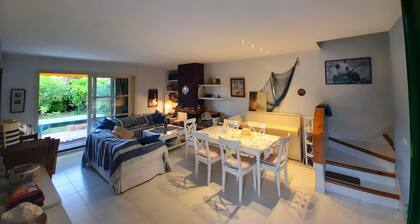 Cozy house with private garden in front of the sea