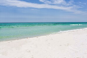 A beach with clear turquoise water and white sand.