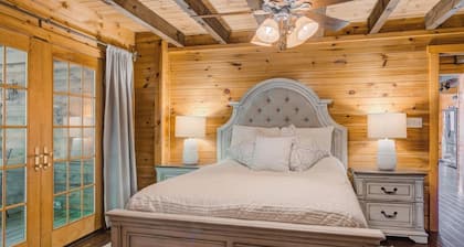 Log Cabin with living room fireplace and hot tub