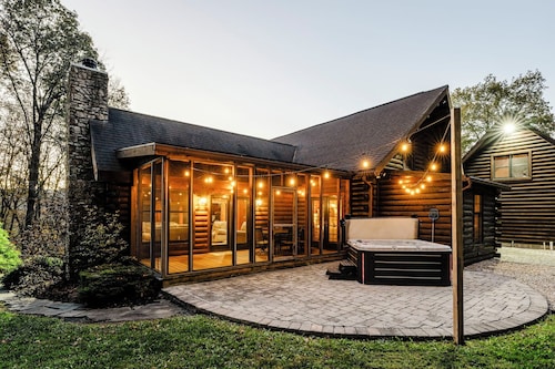 Log Cabin with living room fireplace and hot tub