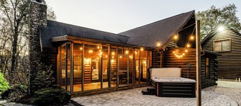 Log Cabin with living room fireplace and hot tub