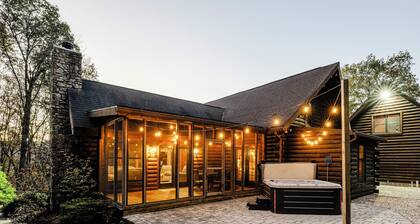 Log Cabin with living room fireplace and hot tub