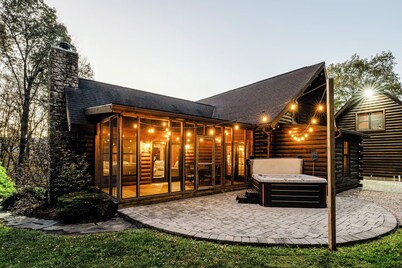Log Cabin with living room fireplace and hot tub