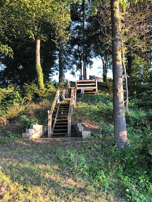 Step up to a serene retreat surrounded by lush greenery and take in the breathtaking view from the elevated platform.
