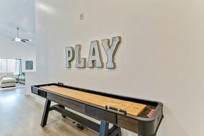 A pool table with 'PLAY' on the wall above it. - 4BR Orem Home | Game Room • Big Yard • Sleeps 13 (Vineyard)