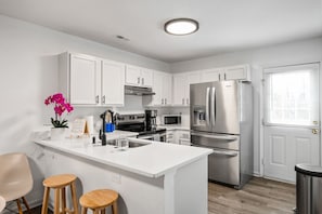 Enjoy cooking in this well-lit kitchen with a central island and stainless steel appliances.
