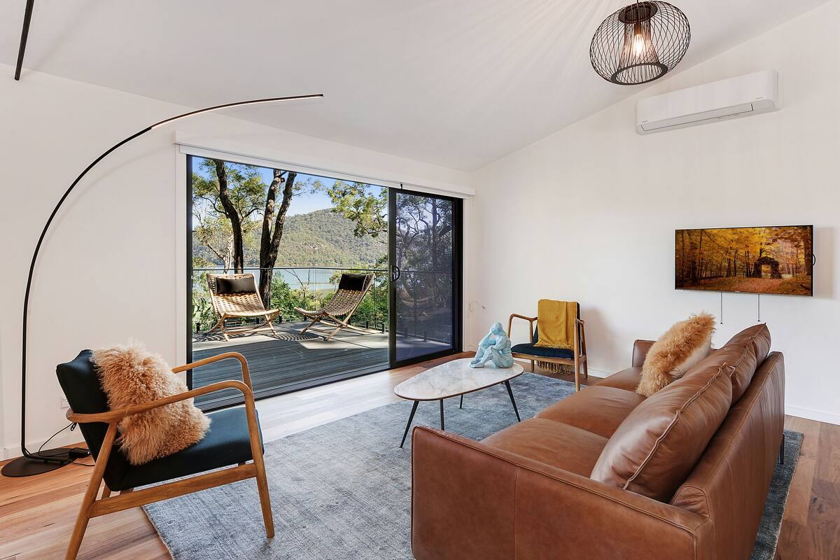 A modern living room with a sofa, chairs, and a coffee table.