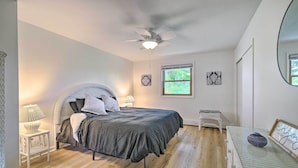 A bedroom with a bed, a ceiling fan, a window, and a small table with a lamp. - Roomy Montour Falls Retreat w/ Private Pool! (Montour Falls)