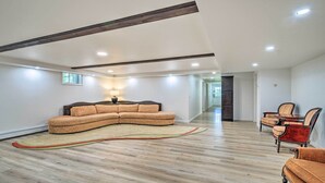 A spacious living room with a sectional sofa, a small rug, and a dining area with chairs. - Roomy Montour Falls Retreat w/ Private Pool! (Montour Falls)