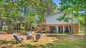 A house with a deck, outdoor seating, and a staircase leading to a porch. - Mt Pleasant Retreat w/ Grill: 10 Mi to Beach (Mt Pleasant)