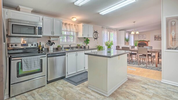 A modern kitchen with stainless steel appliances, white cabinetry, and a central island. - Mt Pleasant Retreat w/ Grill: 10 Mi to Beach (Mt Pleasant)