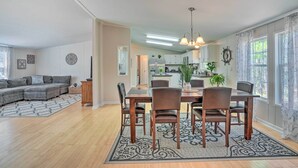 A spacious living room with a sectional sofa, a dining area with a wooden table and chairs, and a kitchen in the background. - Mt Pleasant Retreat w/ Grill: 10 Mi to Beach (Mt Pleasant)