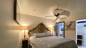 A bedroom with a large bed, two bedside lamps, a ceiling fan, and a painting on the wall. - Downtown Tempe House Beauty with yard! Mill 3 blocks. ASU half mile.  (Tempe)