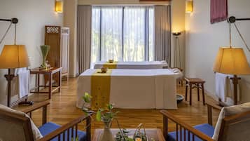 Relax in a stylishly designed room with a large bed, two bedside tables, and a comfortable chair.