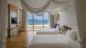 A hotel room with a large bed, a desk, and a TV. - Ana Mandara Cam Ranh (Cam Lam)