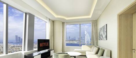 Deluxe Apartment | Living area | 55-inch Smart TV with cable channels, TV, Netflix