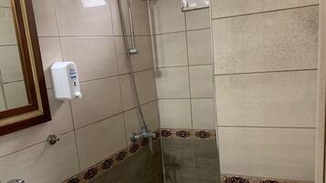 A bathroom with a sink, toilet, and shower.