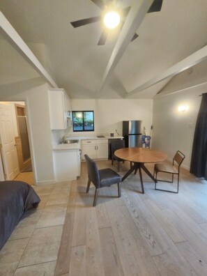 A compact living space with a dining area, kitchenette, and a ceiling fan. - Westside Living! Contemporary Venice Beach Studio Suite (Los Angeles)