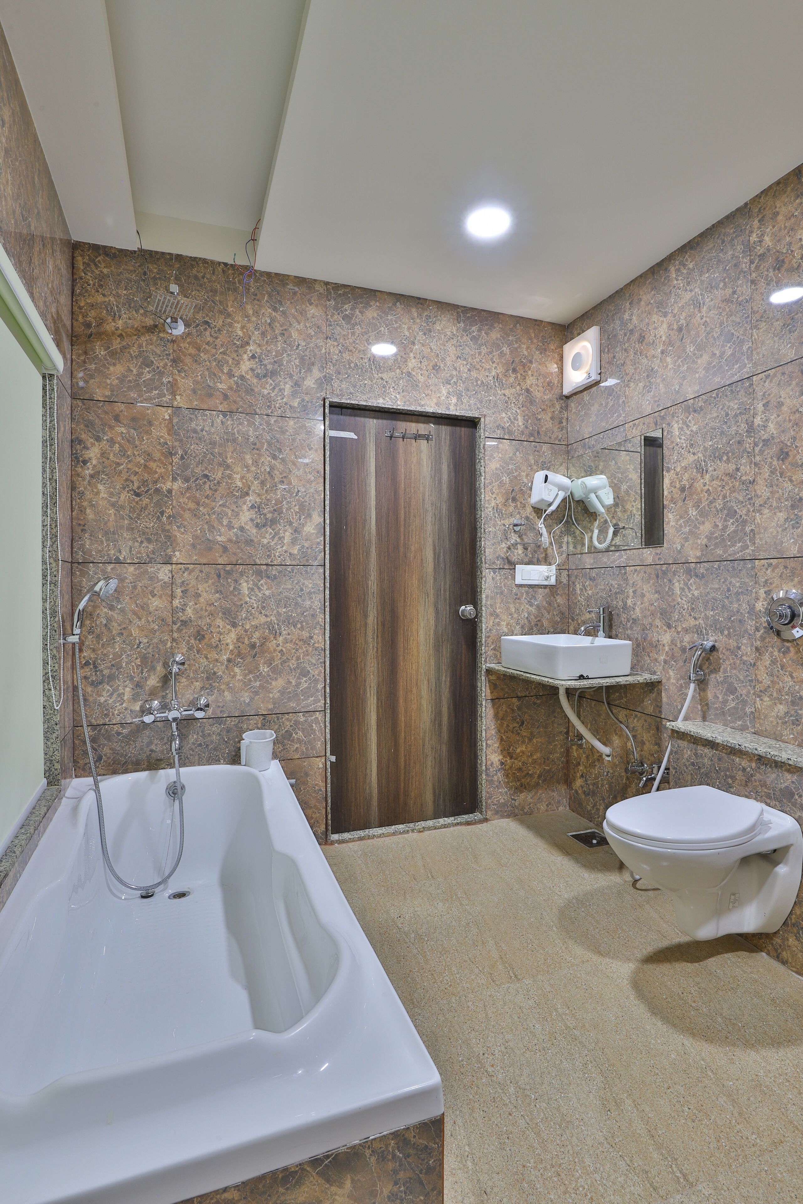 A bathroom with a bathtub, sink, and toilet.